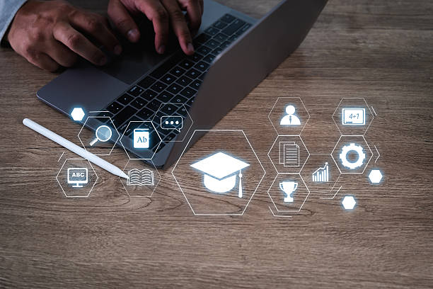 istock E-learning Platforms person working laptop with digital education icons floating above desk, symbolizing online learning and digital education 2221219923