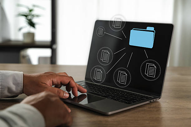 istock Office files report document person working laptop with digital file icons and folder graphic screen, indicating data management or organization 2221219929