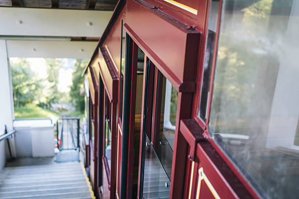 Profile view of funicular train travelling up mountain in summer Monte Bre, Lugano, Ticino Canton