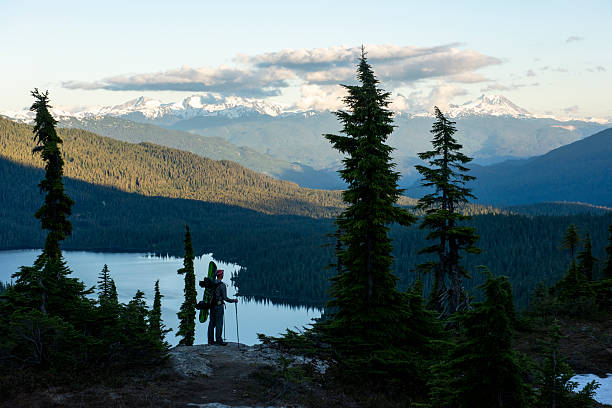 istock Backcountry splitboarder on hill above lake at dusk 2221224372