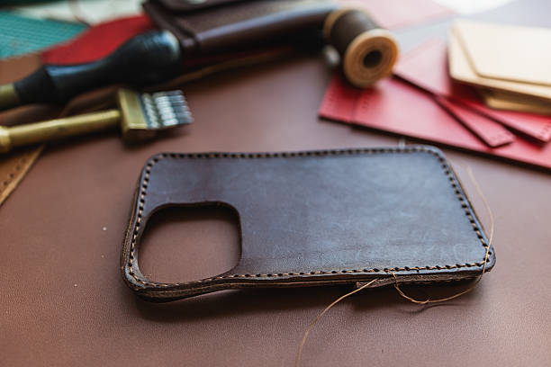 istock Craftmanship of genuine leather phone case handmade working 2221232055