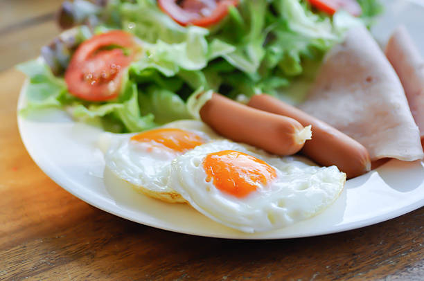 egg , sausage and ham with vegetable or sunny side up egg for serve