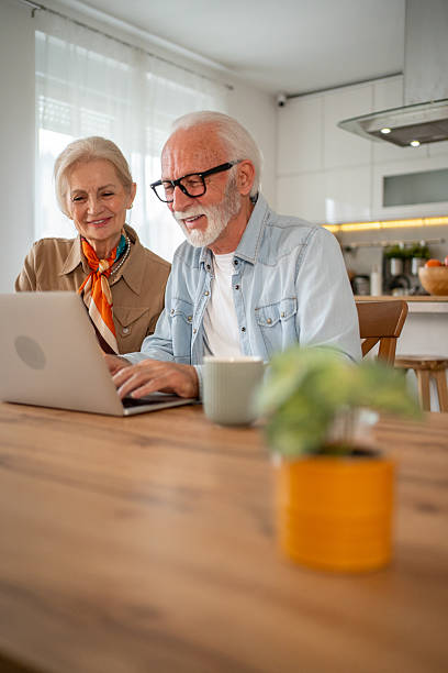 istock Senior couple browsing internet on laptop at home 2221238944