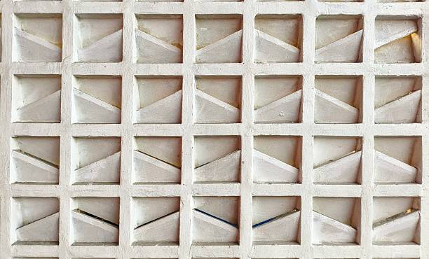 istock Close-up of a white concrete architectural element with square grid and diagonal shapes 2221239212