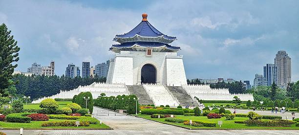 Taipei, Taiwan - Jun 08, 2025: Taipei iconic landmark of Chiang Kai-shek Memorial Hall stands prominently under a partly cloudy sky