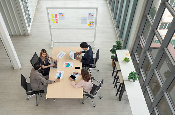 istock High-powered business professional discussing strategic plan and making decision at a conference table in a professional office setting. 2221251159