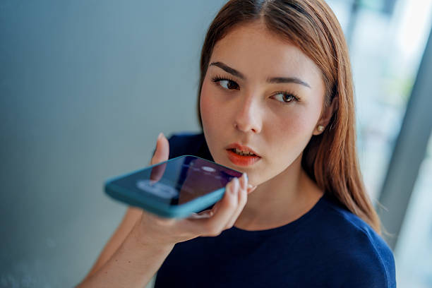 istock Young woman is using smartphone to interact with chatbot assistant, showcasing integration of AI technology in daily life. Her expression reflects curiosity and engagement 2221256609