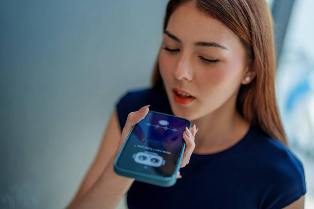 istock Young woman interacts with smartphone using voice assistant, showcasing integration of AI technology in daily life. This moment highlights convenience of using chatbot for assistance 2221256642