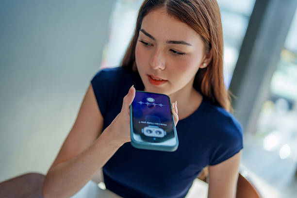 istock Young woman interacts with smartphone, using voice assistant feature. scene captures modern integration of technology in daily life, showcasing convenience of AI and chatbots in communication 2221256644