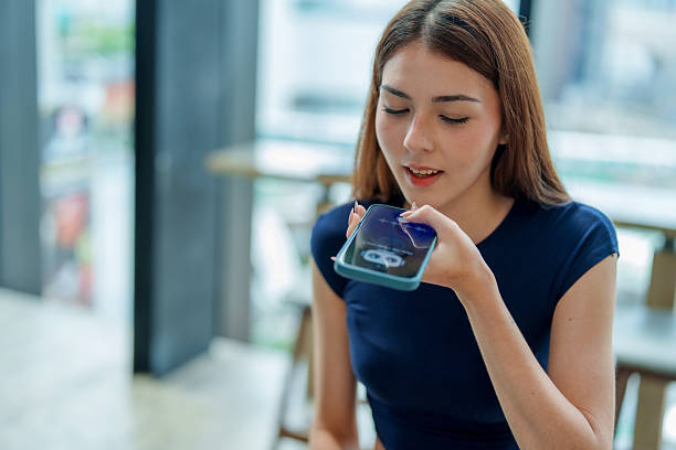 istock Young woman is using smartphone to interact with voice assistant, showcasing convenience of technology in daily life. This scene highlights role of AI and chatbots in enhancing communication 2221256693