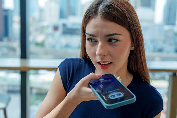 istock Young woman is using smartphone to interact with chatbot assistant, showcasing modern technology vibrant urban setting. scene reflects integration of AI daily life, enhancing communication 2221256717