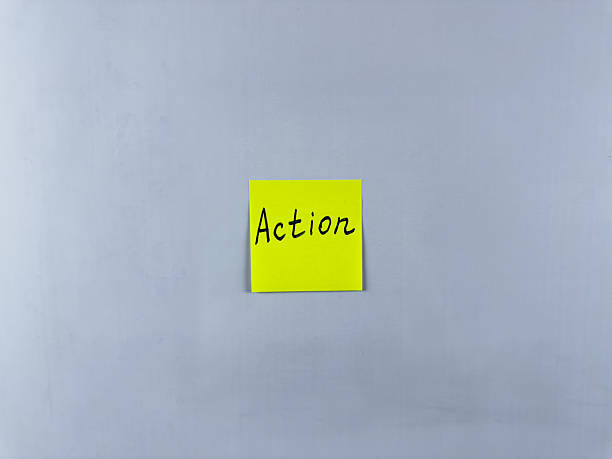 istock Sticky note with the word Action written on it, placed on white background. Ideal for illustrating themes of initiative, movement, and productivity. Great for concept creation 2221256800