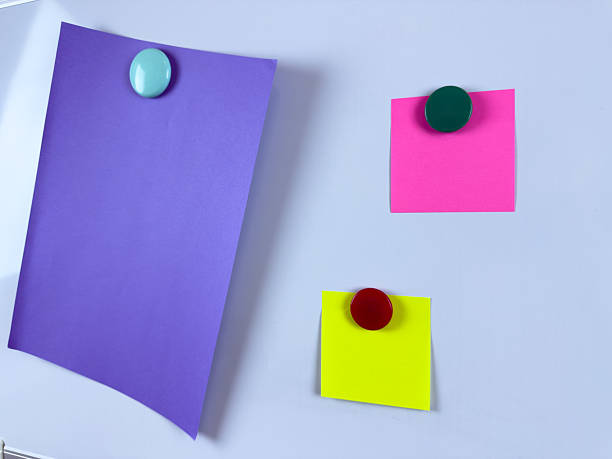 istock Three brightly colored paper notes attached to whiteboard with magnets perfect for scheduling and memos increasing efficiency and organization in office school or home settings 2221264614
