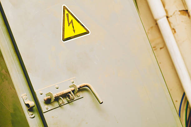 istock Gray doors with a lock, electric shock hazard sign zone 2221268520
