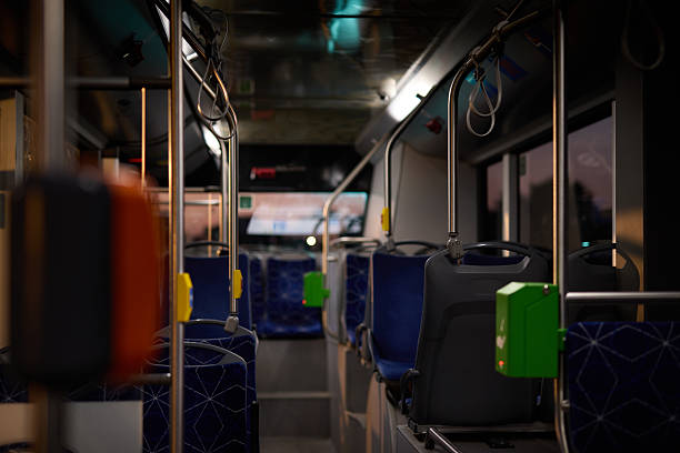 istock Empty bus at night showing seats and handles 2221272489