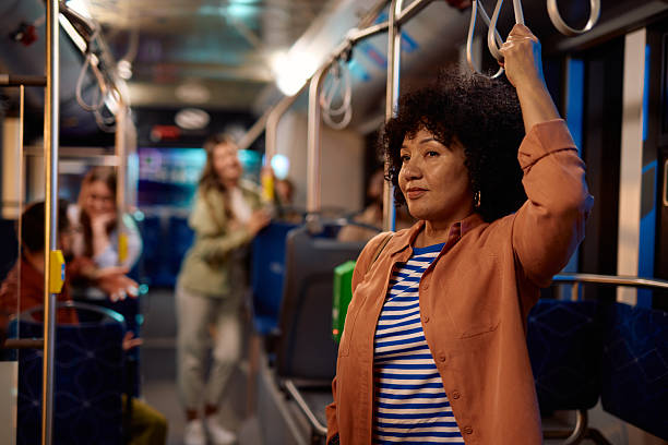 istock Mature woman commuting by bus holding a handle 2221272585