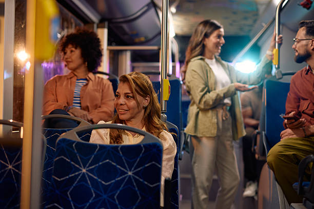 istock Diverse group of people using public transport at night 2221272629