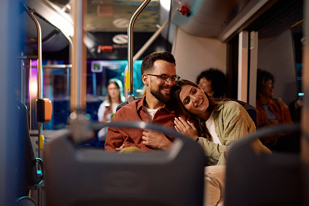 istock Happy couple embracing while traveling by bus at night 2221272635