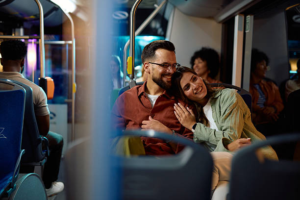 istock Young couple embracing while traveling by bus at night 2221272694
