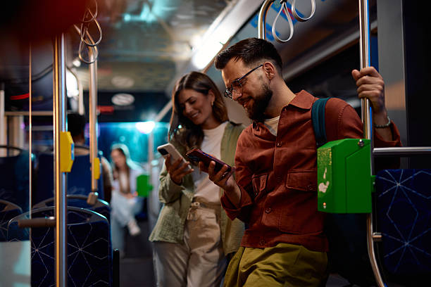 istock Young professionals using smartphones on a modern bus at night 2221272710