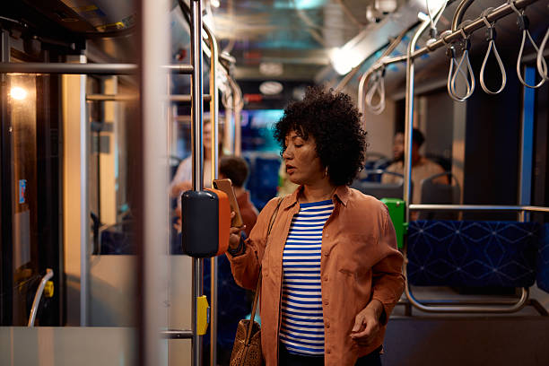 istock Woman validating bus ticket with smartphone NFC technology 2221272740
