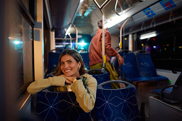 istock Young woman commuting by bus at night looking at camera 2221272780