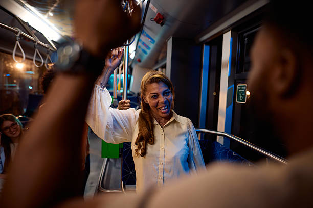 istock Woman laughing while standing on a moving bus at night 2221272861
