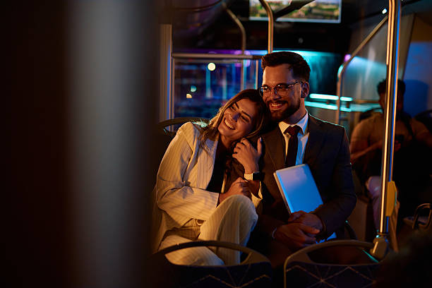 istock Happy business couple embracing while commuting by bus at night 2221272918