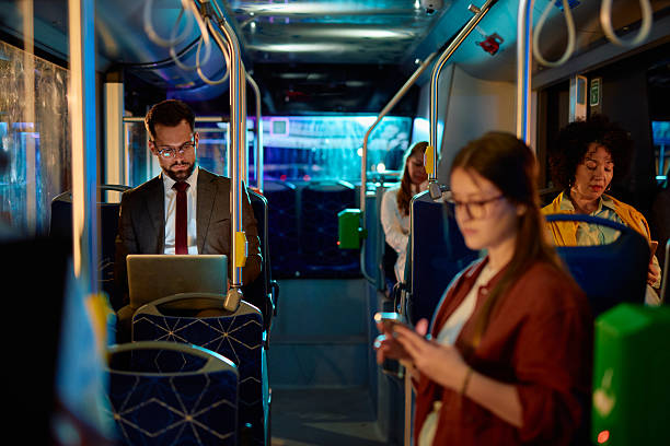 istock Businessman working on laptop while commuting by bus at night 2221273358