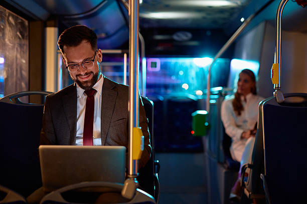 istock Businessman working on laptop while commuting by bus at night 2221273474