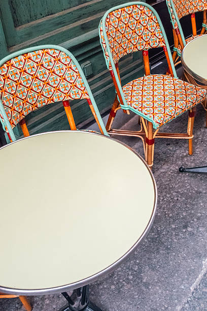 istock Colorful Patterned Chairs and Round Table at an Outdoor Cafe 2221273544