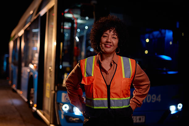 istock Confident female bus driver smiling at night shift 2221273552