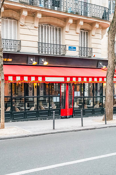 istock Classic Parisian Cafe Exterior with Red Awning and Sidewalk View 2221273781