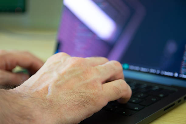 Close image of a man working with laptop