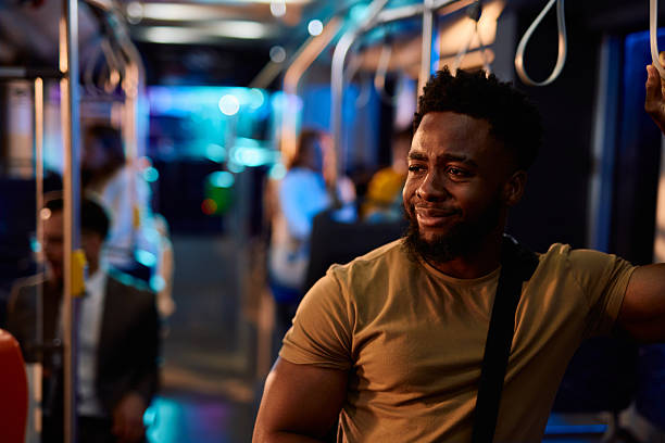 istock Young black man commuting by bus at night looking away 2221275054