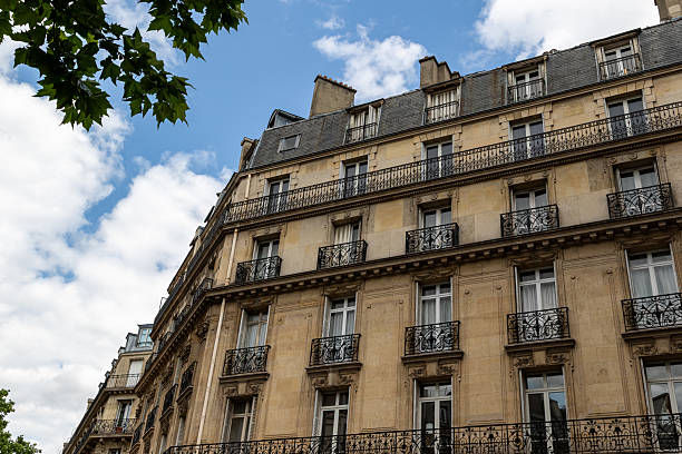 istock Apartment Building Facade with Balconies and Windows Under Cloudy Sky 2221275313