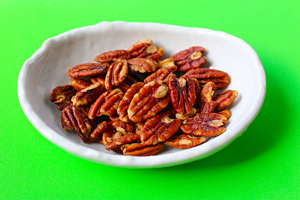 istock Delicious salted pecan nuts scattered. 2221275937