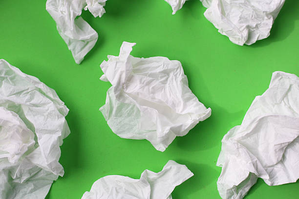 istock Used crumpled tissues scattered on a green surface. 2221278725