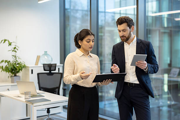 istock Business colleagues discuss a project in a modern office environment, collaborating on ideas. 2221280710