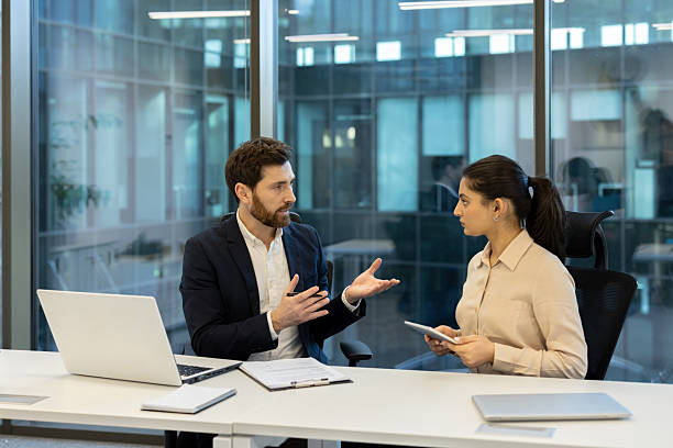 istock A team of professionals in a modern office having an important discussion at a table. 2221280773