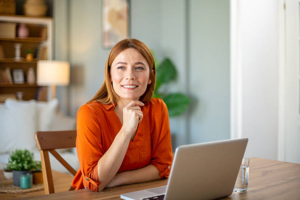 istock Happy freelancer woman working from home using laptop computer 2221287895