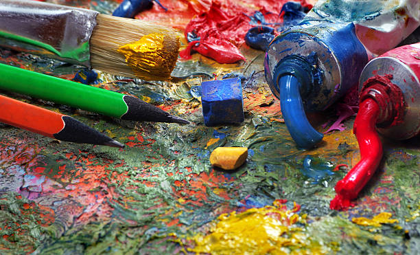 istock artist's palette, tubes and brushes on a table 2221288410