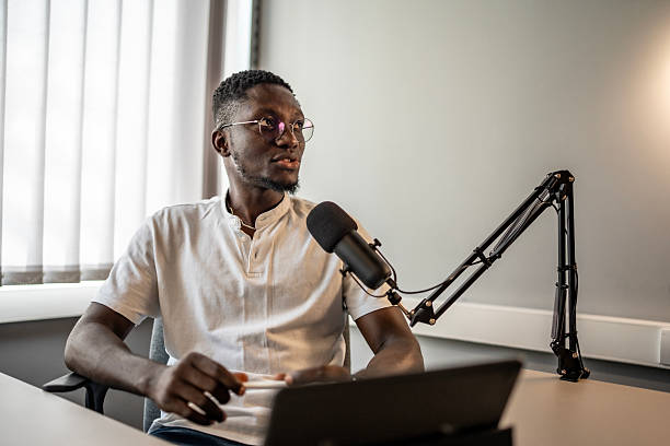 istock Young Professional Recording Podcast in Studio with Microphone and Laptop 2221295283