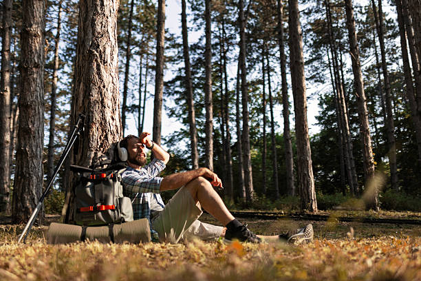 istock Backpacker Sitting in the Woods for a Rest Stop 2221298541