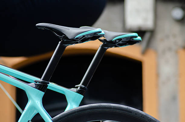 two modern bicycle saddles with teal accents