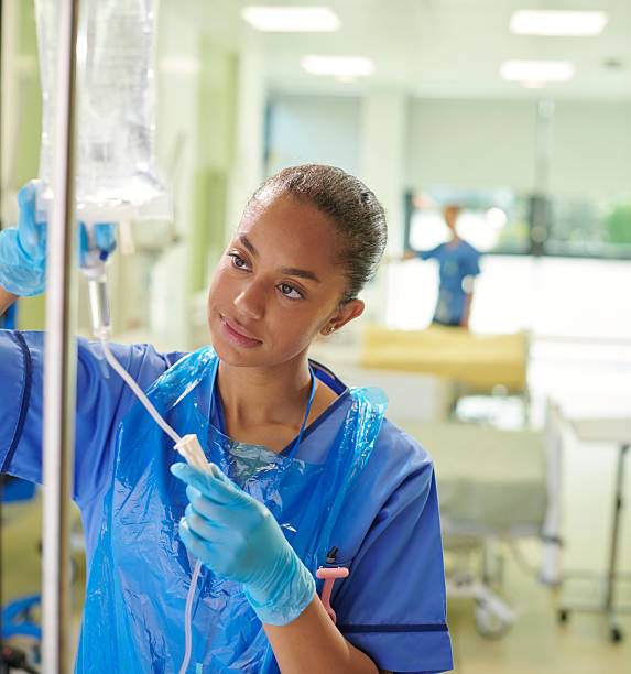 young nurse adjusting iv drip