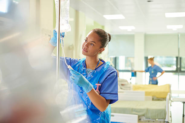 young nurse adjusting iv drip