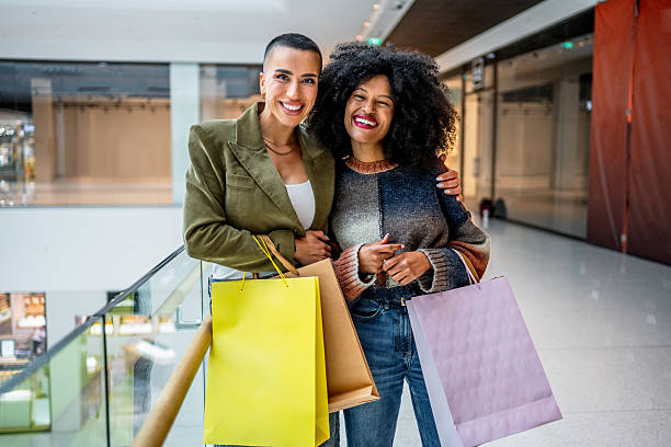 istock Two smiling women shopping in a mall 2221311865