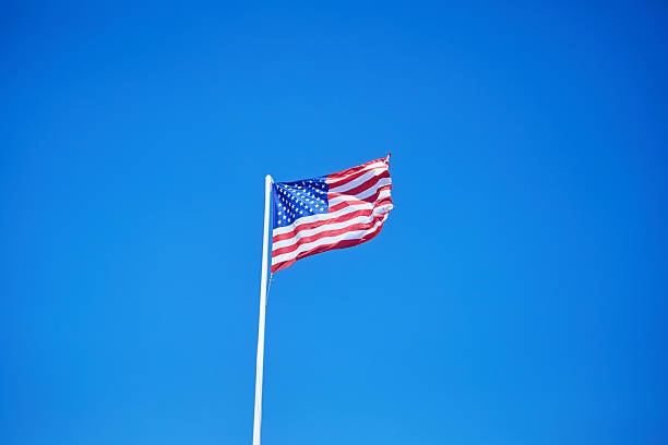 istock USA flag on the blue sky 2221315571