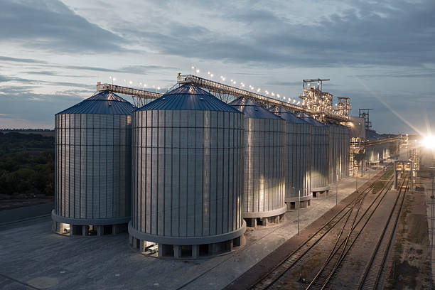 istock Illuminated Grain Silos and Industrial Elevator at Night with Railway Tracks Modern Agriculture Concept 2221317893